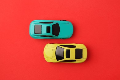 Photo of Different bright cars on red background, flat lay