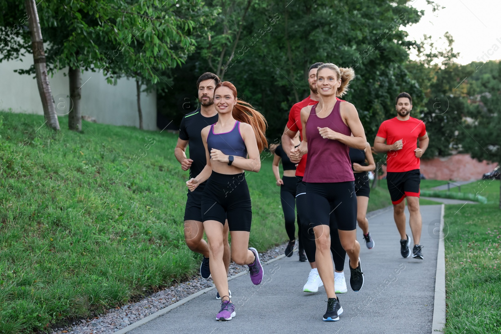 Photo of Group of people running outdoors. Active lifestyle