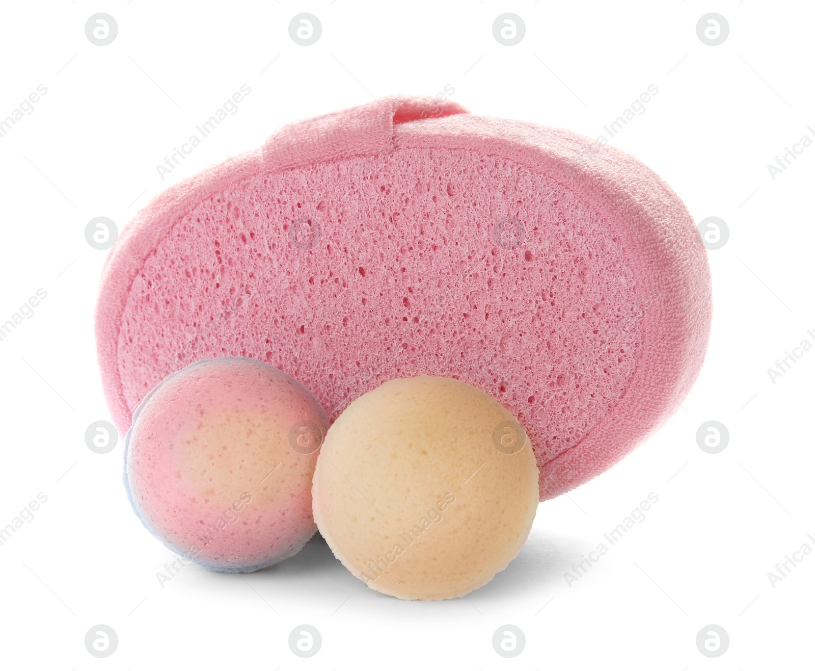 Photo of Pink sponge and bath bombs on white background