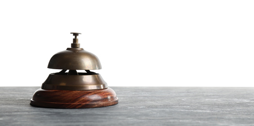 Hotel service bell on grey stone table against white background