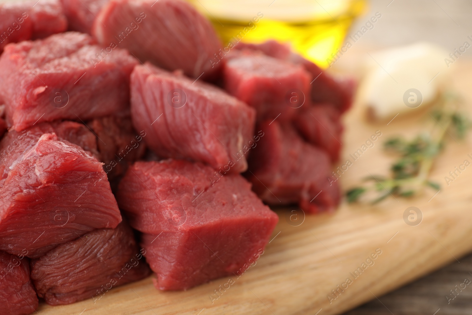 Photo of Pieces of raw beef meat on table, closeup. Space for text