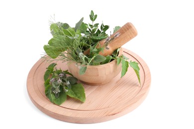 Photo of Wooden board and mortar with different herbs, flowers and pestle on white background