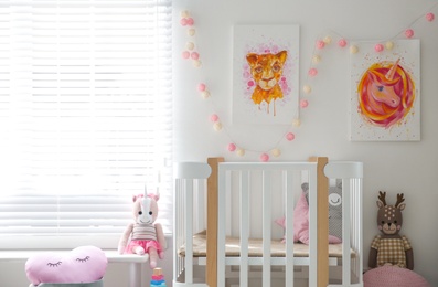 Photo of Cute pictures and crib in baby room interior