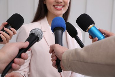 Photo of Happy business woman giving interview to journalists at official event, closeup