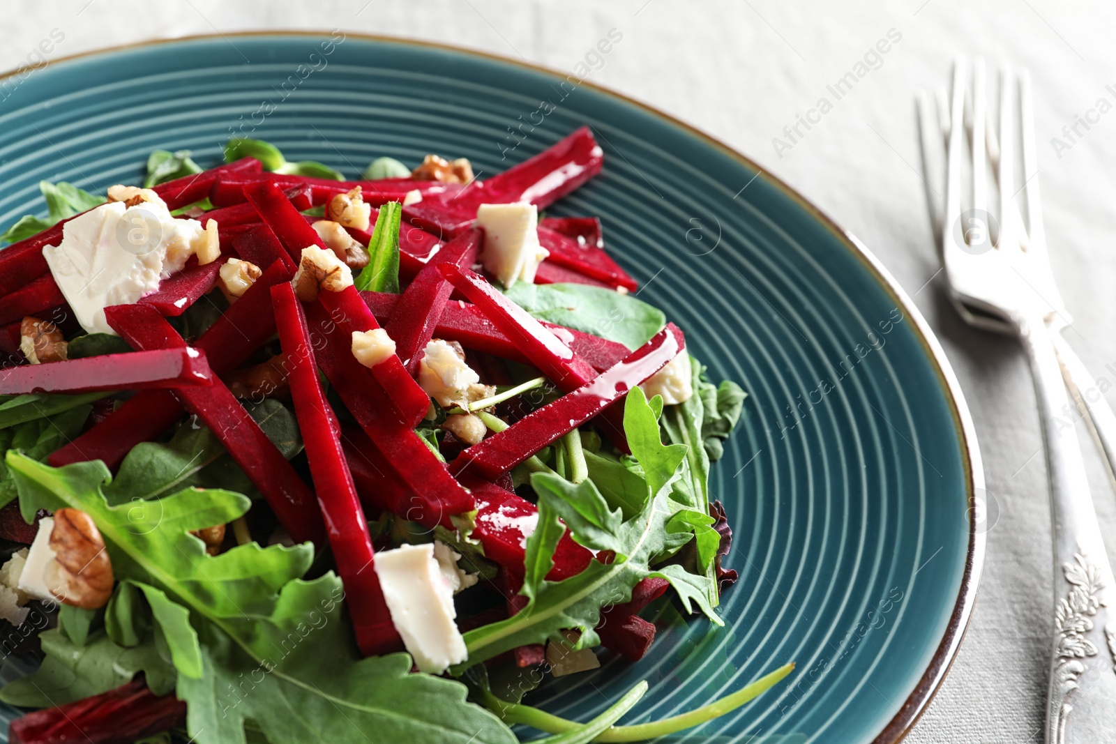 Photo of Plate with delicious beet salad on table, closeup