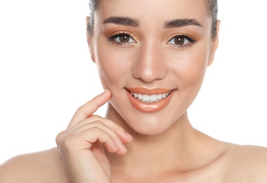 Photo of Beautiful young woman with glitter makeup on white background