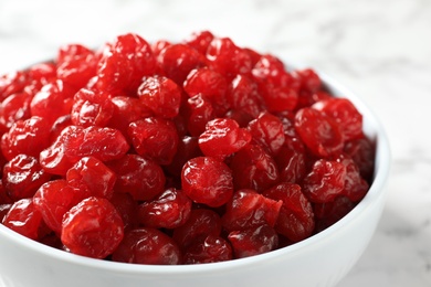 Photo of Bowl of sweet cherries on marble background, closeup. Dried fruit as healthy snack