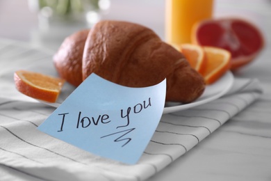 Romantic breakfast with note saying I Love You on table