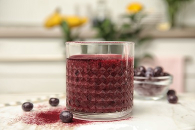 Photo of Glass with delicious acai smoothie on table, closeup