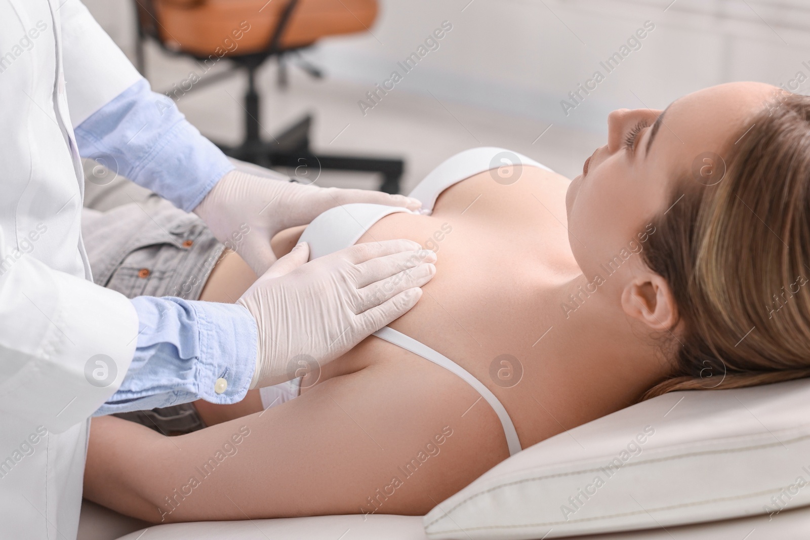 Photo of Mammologist checking young woman's breast in hospital