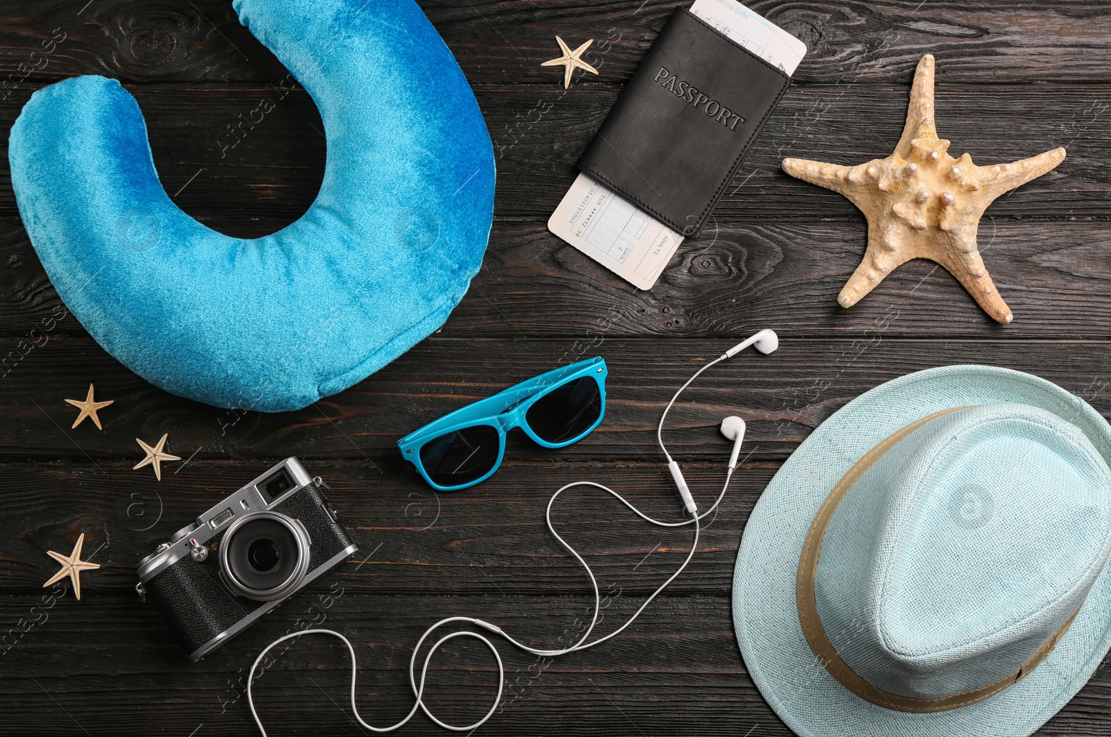 Image of Flat lay composition with blue travel pillow on wooden background