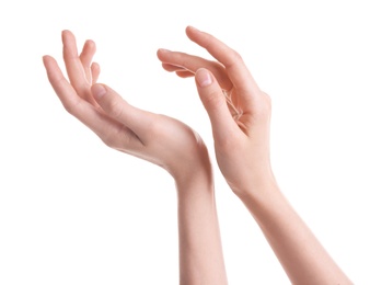 Young woman against white background. Focus on hands moisturized with cream