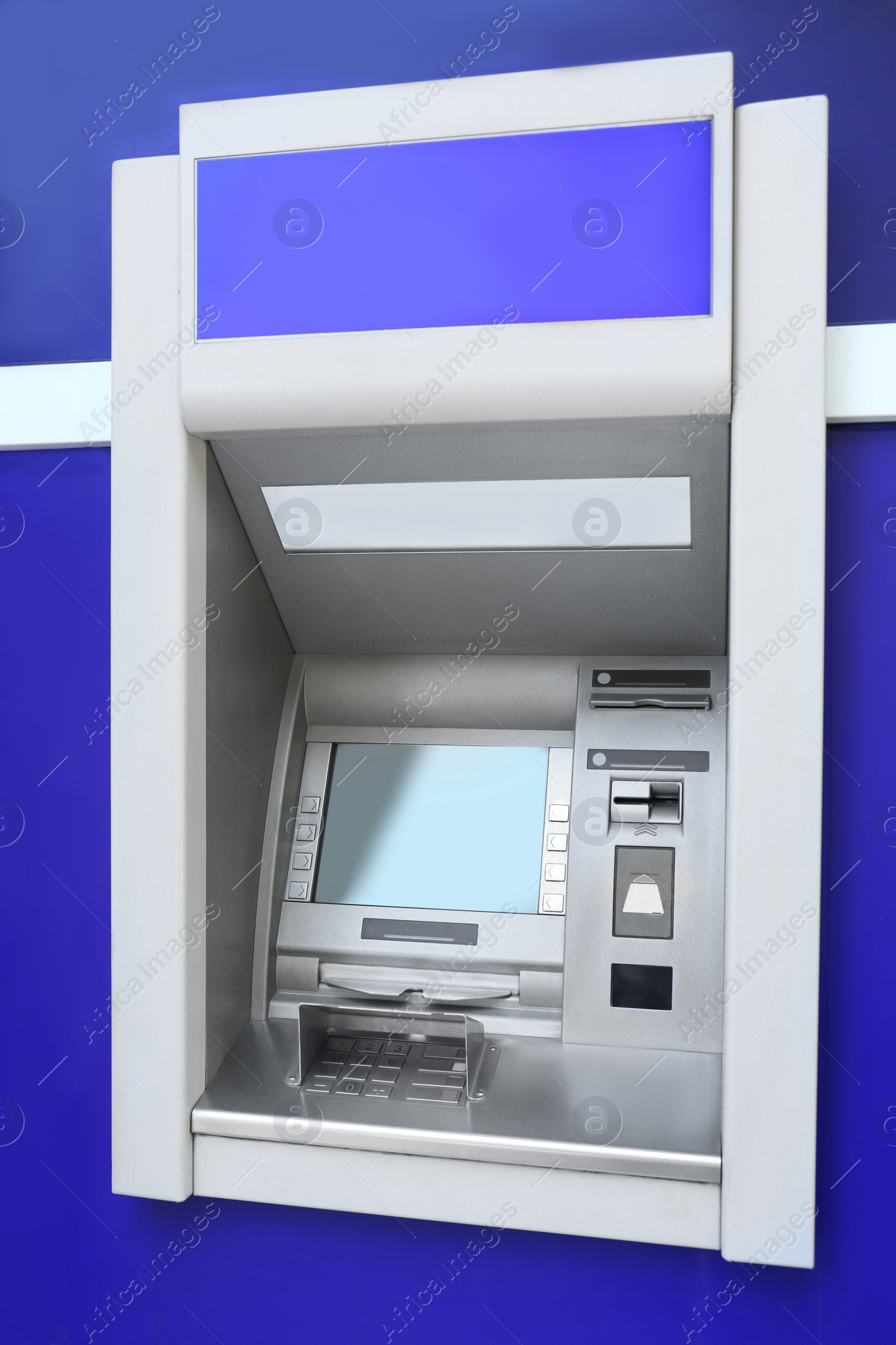 Photo of Modern color automated teller cash machine outdoors