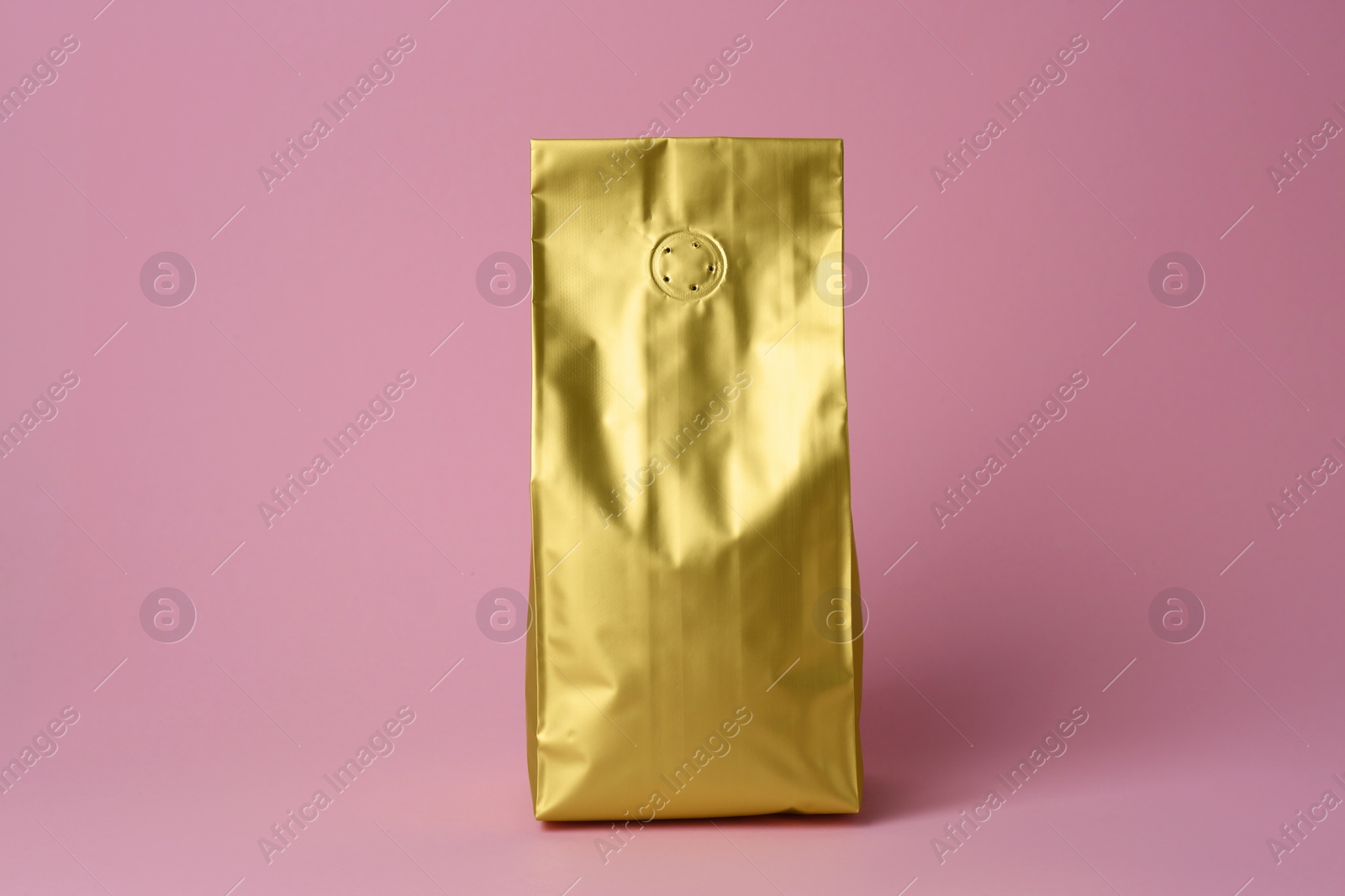 Photo of One blank foil package on pink background