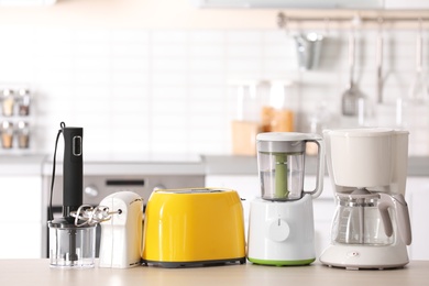 Photo of Kitchen appliances on table against blurred background