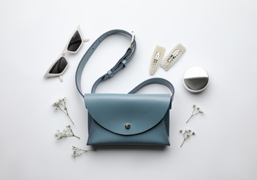 Photo of Flat lay composition with stylish woman's bag on light background