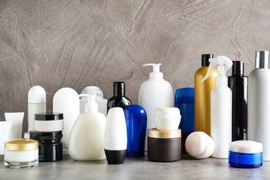 Photo of Different body care products on table against grey background