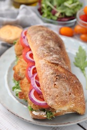 Photo of Delicious sandwich with schnitzel on white wooden table, closeup