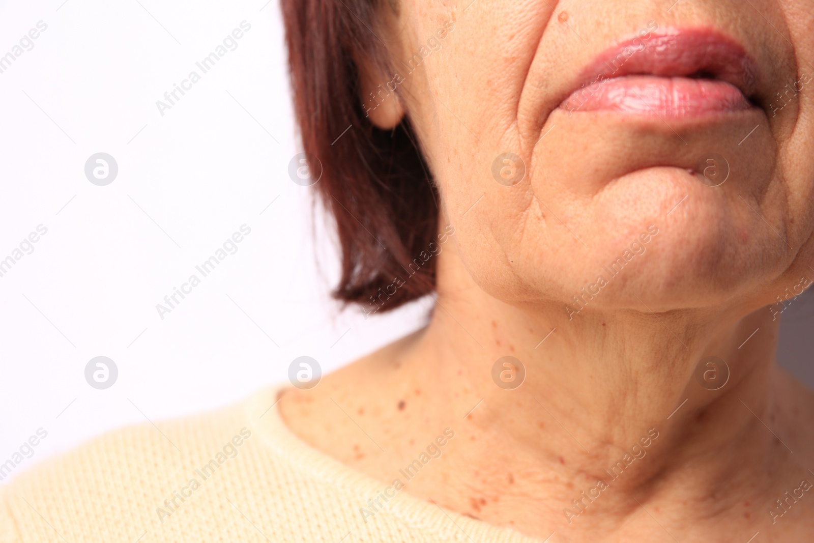 Photo of Closeup view of older woman on white background
