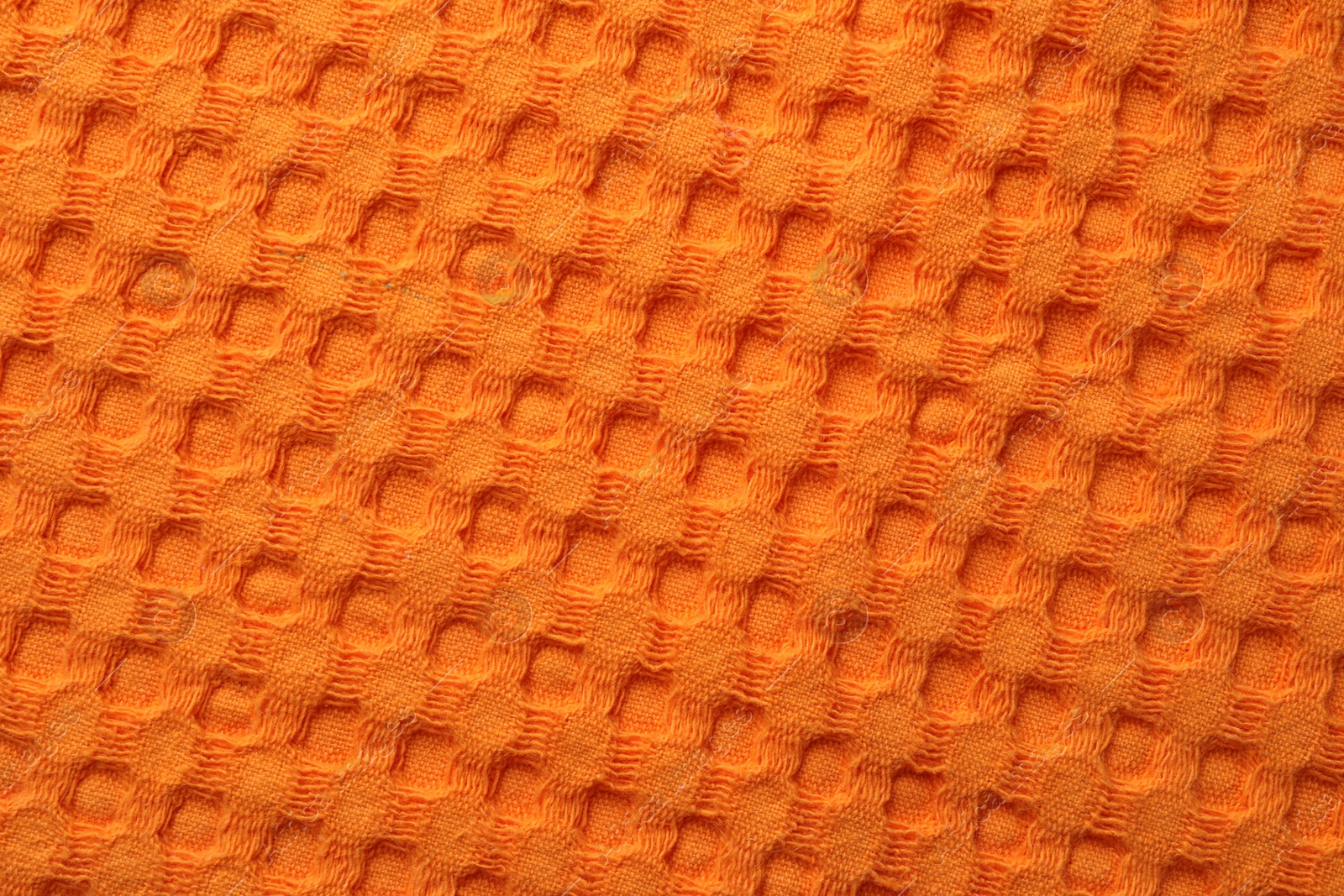 Photo of Texture of orange knitted fabric as background, top view