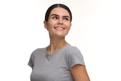 Young woman with clean teeth smiling on white background