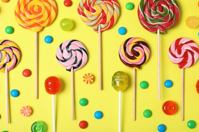 Photo of Flat lay composition with different candies on color background