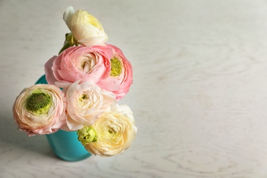 Photo of Beautiful ranunculus flowers on light background