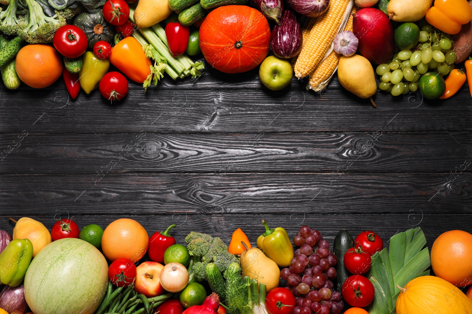 Photo of Assortment of fresh organic fruits and vegetables on black wooden table, flat lay. Space for text