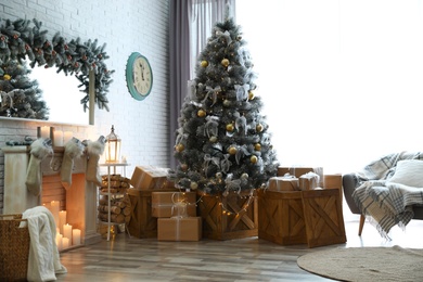 Photo of Stylish interior with decorated Christmas tree in living room