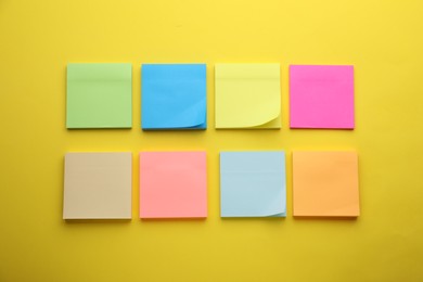 Photo of Paper notes on yellow background, flat lay