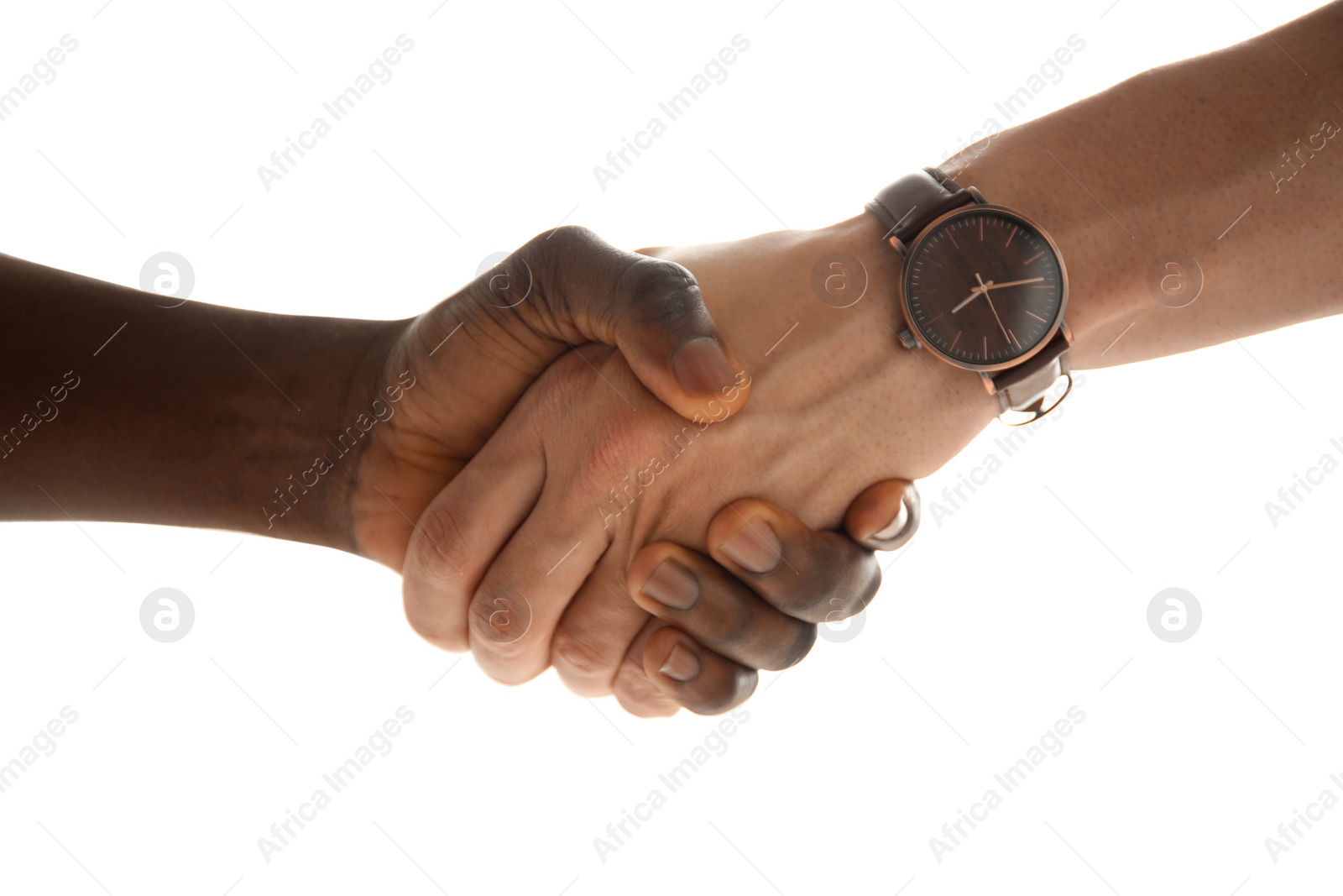 Photo of Men shaking hands on light background, closeup. Unity concept