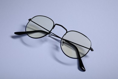 Photo of Stylish pair of glasses with black frame on white background, closeup