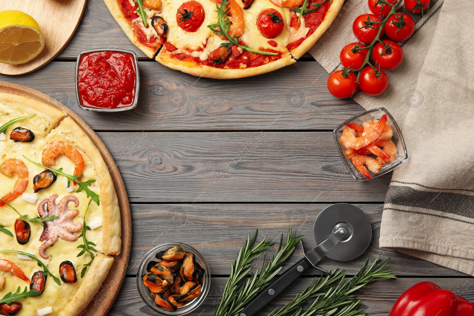 Photo of Delicious seafood pizza on wooden table, flat lay. Space for text