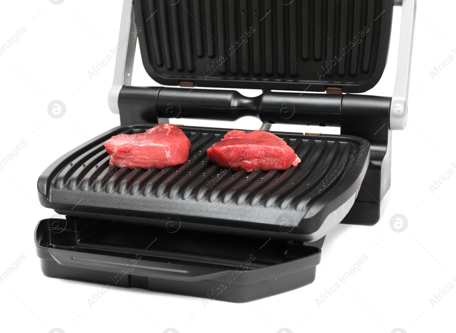 Photo of Electric grill with raw meat steaks isolated on white