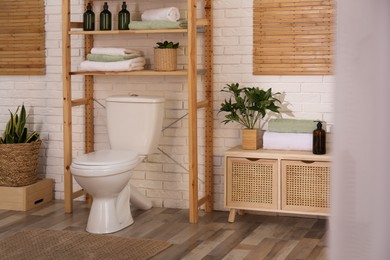 Photo of Stylish bathroom interior with toilet bowl and other essentials