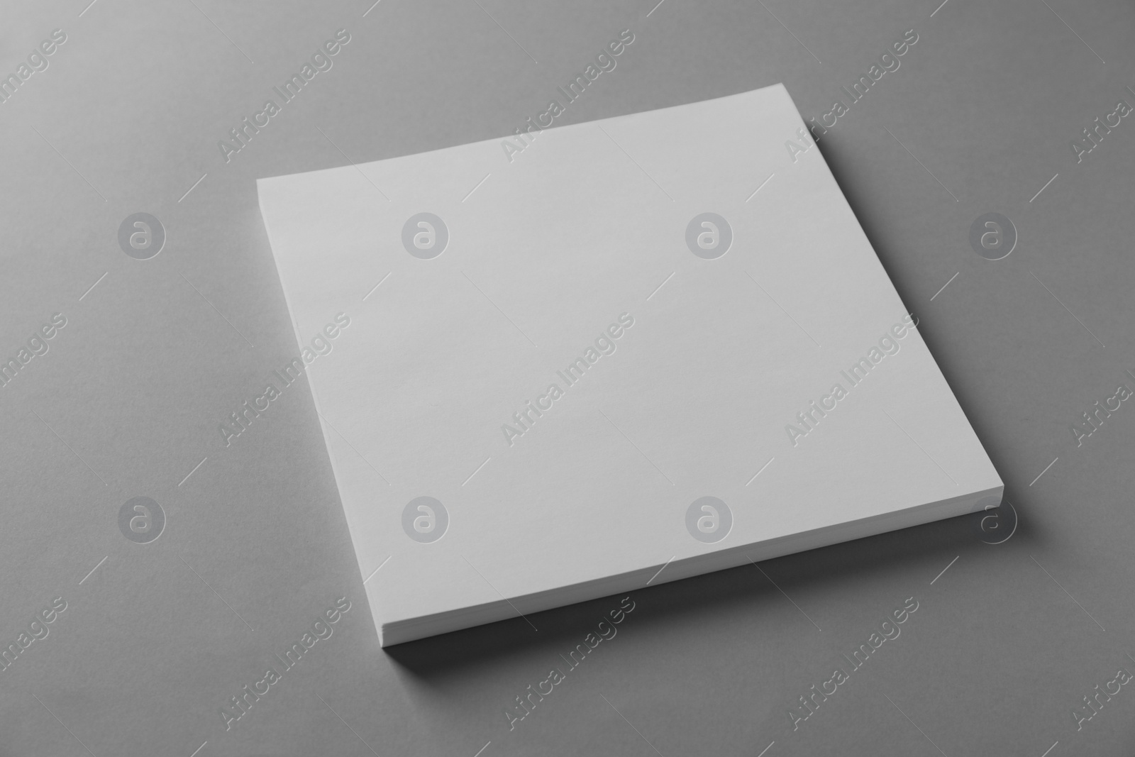 Photo of Stack of blank paper sheets for brochure on light grey background