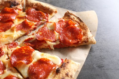 Photo of Tasty pepperoni pizza on grey table, closeup