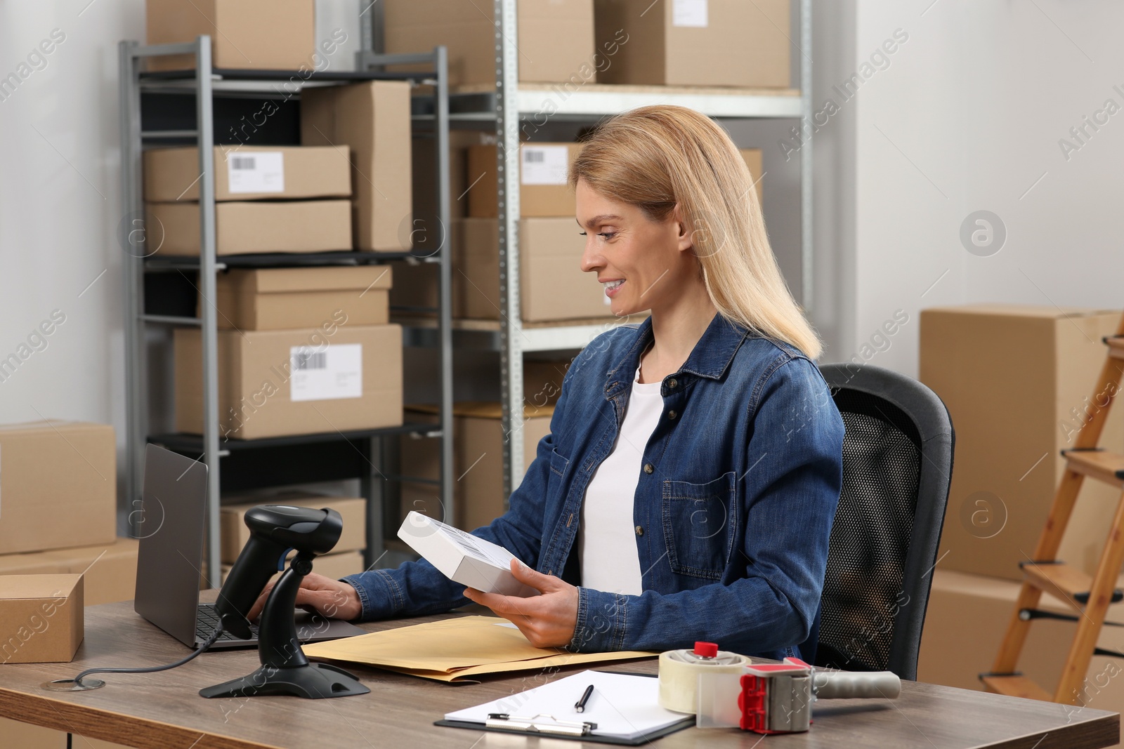 Photo of Seller with parcel in office. Online store