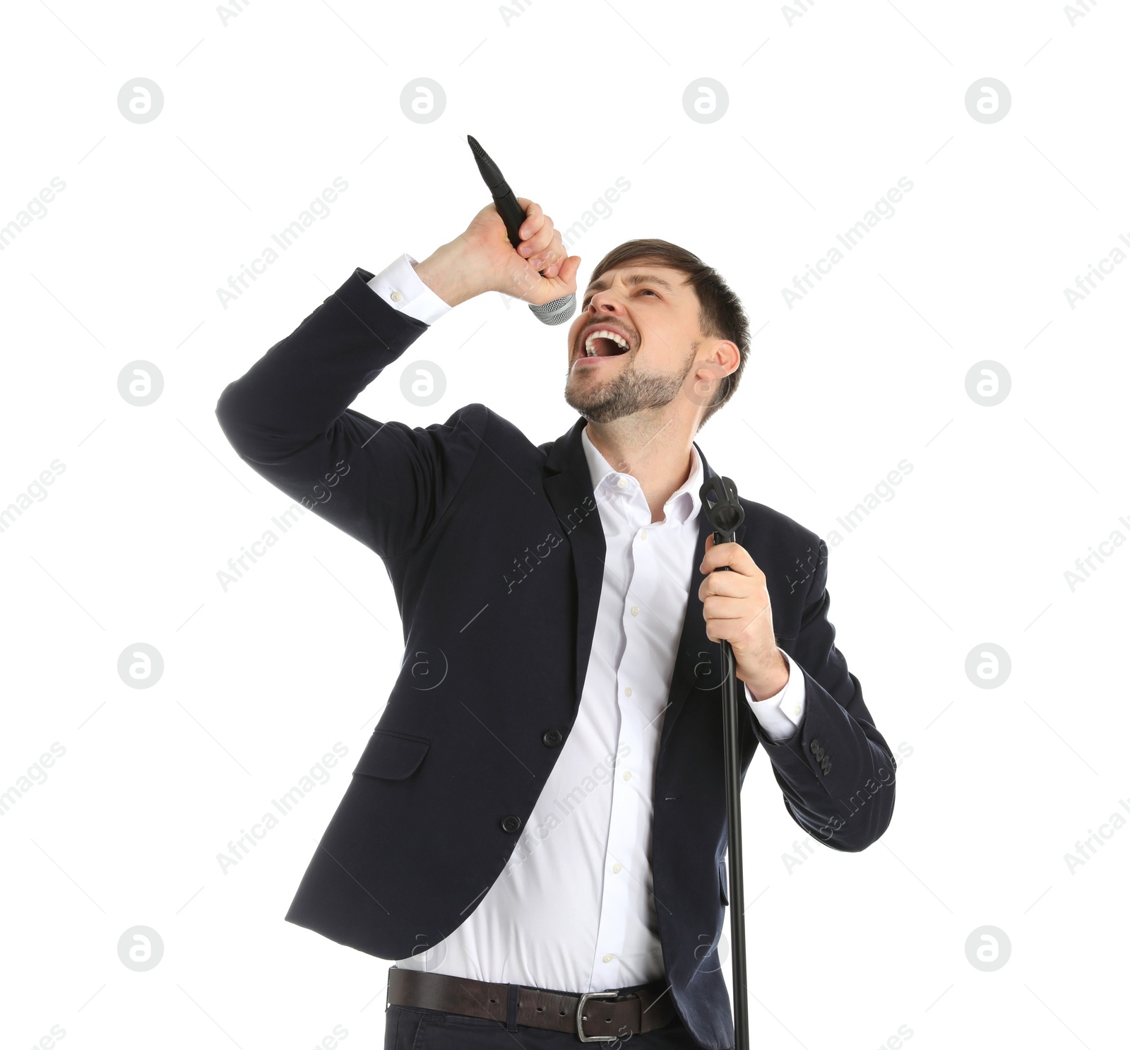 Photo of Handsome man in suit singing with microphone on white background