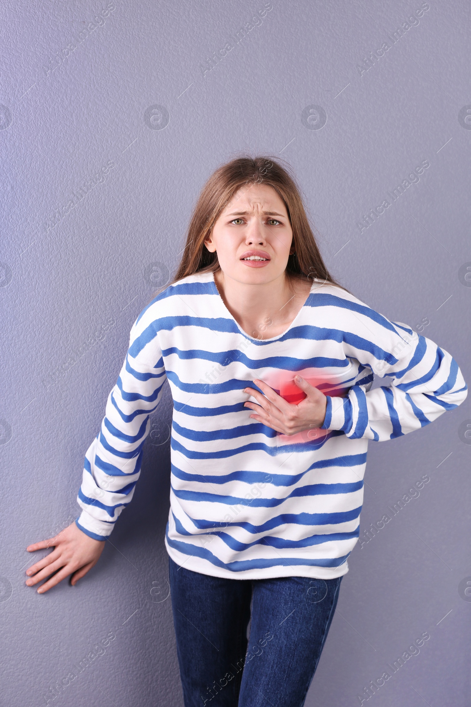 Photo of Young woman having heart attack on color background