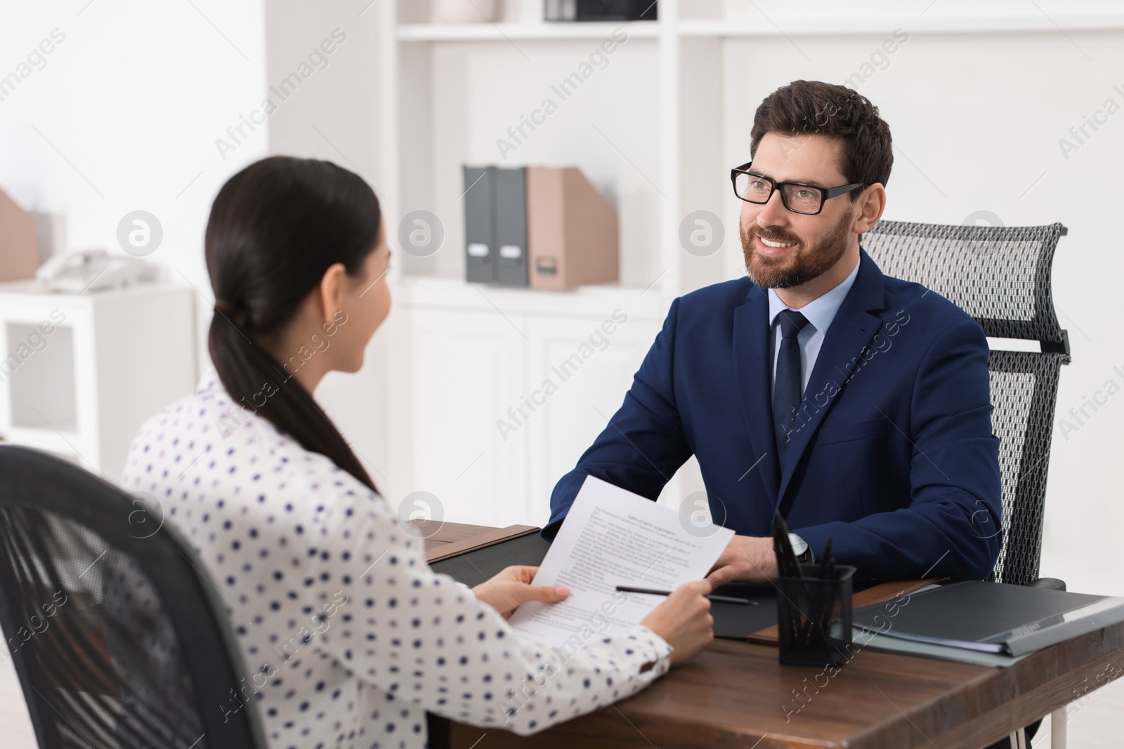 Photo of Woman having meeting with lawyer in office, selective focus