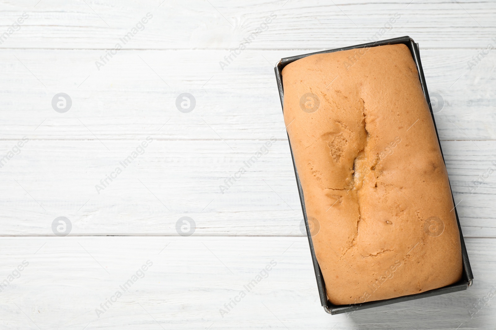 Photo of Tasty pear bread on white wooden table, top view
 with space for text. Homemade cake