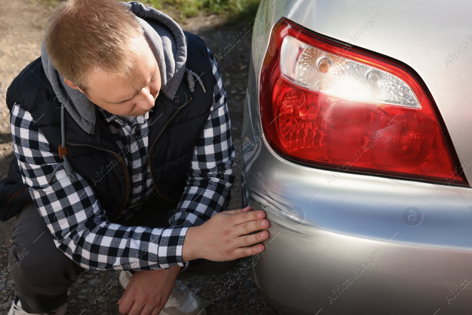 Photo of Stressed man near car with scratch outdoors