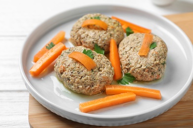 Plate of traditional Passover (Pesach) gefilte fish on table, closeup