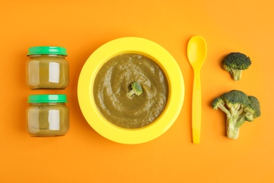 Photo of Flat lay composition with healthy baby food and broccoli on orange background