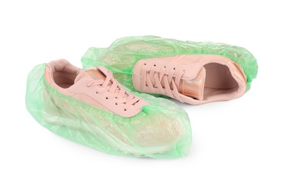 Sneakers in green shoe covers isolated on white