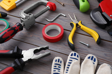 Photo of Different construction tools on grey wooden background