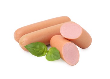 Photo of Whole and cut delicious boiled sausages with basil on white background