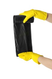 Janitor in rubber gloves holding roll of black garbage bags on white background, closeup