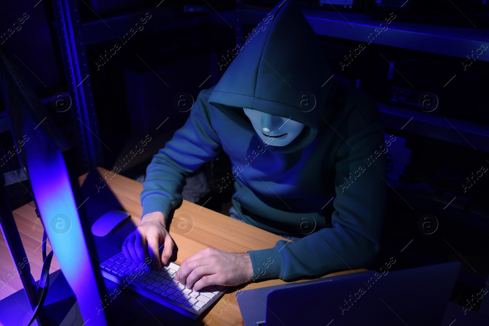 Photo of Hacker working with computers in dark room. Cyber attack